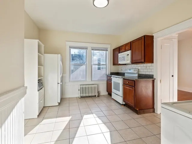 a kitchen with stainless steel appliances a stove a sink and a refrigerator
