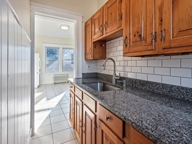 a kitchen with stainless steel appliances granite countertop a sink and a cabinets