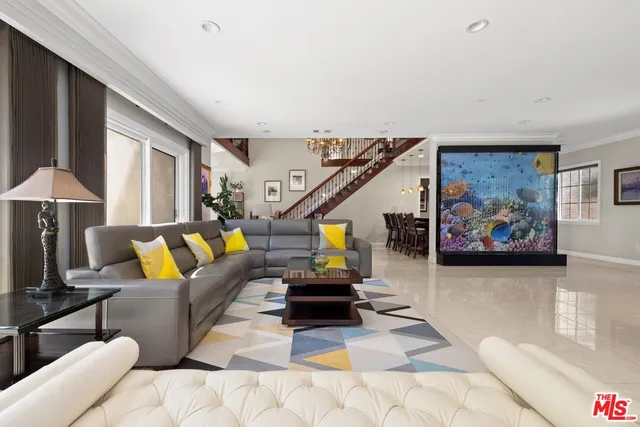 a living room with a flat screen tv and pool table