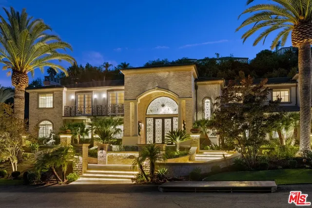 a living room with furniture a chandelier and a rug