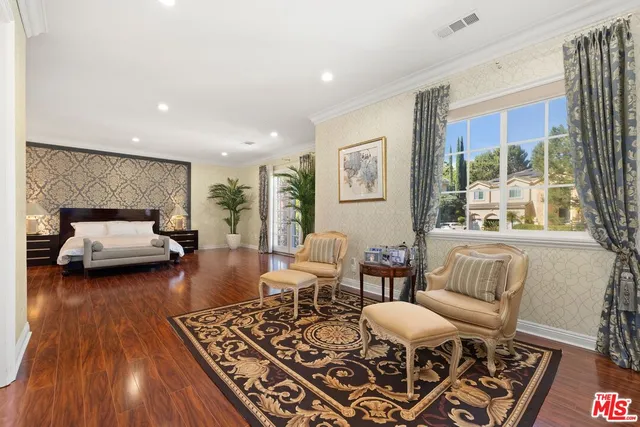 a living room with furniture fireplace and a large window