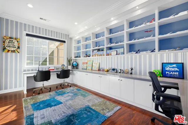a view of a roof deck with table and chairs under an umbrella with wooden floor