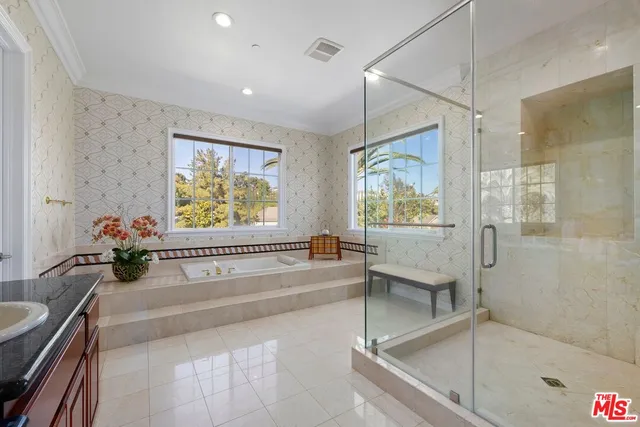 a view of a swimming pool with lounge chairs on the roof deck
