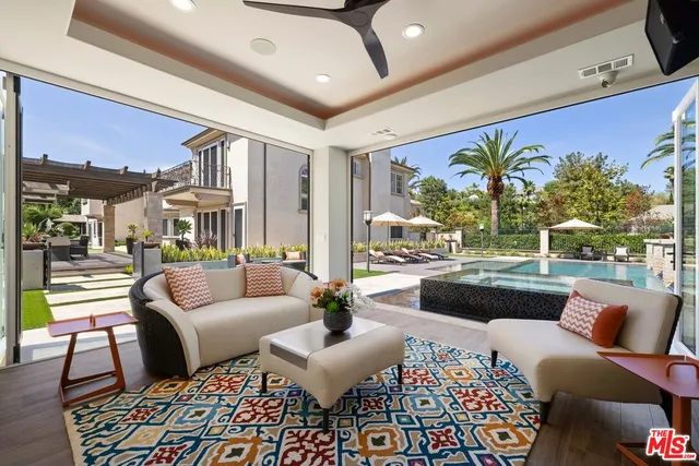 a view of a patio with a table chairs and a yard