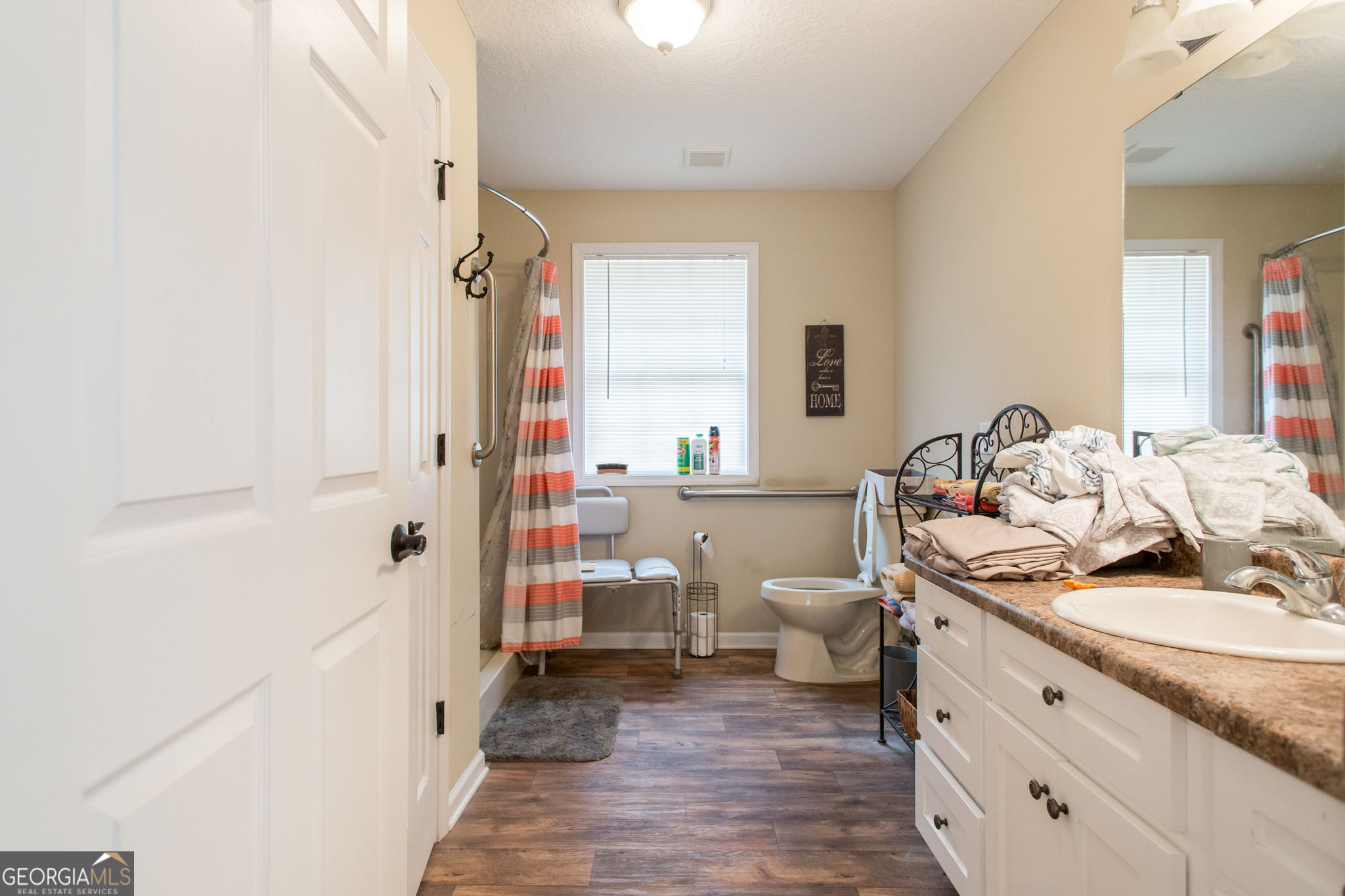 920 Wilfred Street Waycross, GA 31503 - Photo 15 of 17 a bathroom with a granite countertop sink a toilet and shower