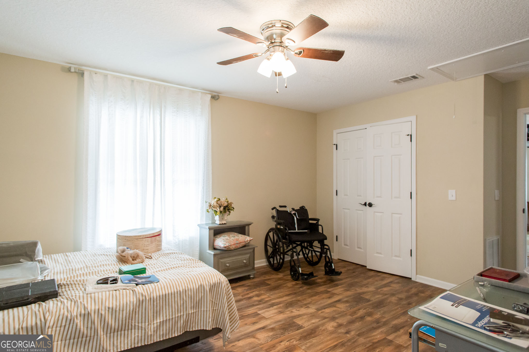 920 Wilfred Street Waycross, GA 31503 - Photo 17 of 17 a bedroom with bed and a chandelier