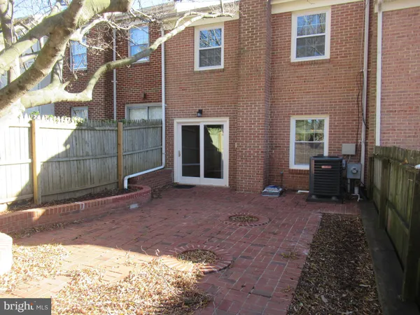 a backyard of a house with barbeque oven table and chairs