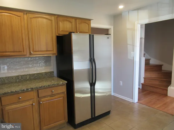 a kitchen with metallic refrigerator freezer and a dishwasher