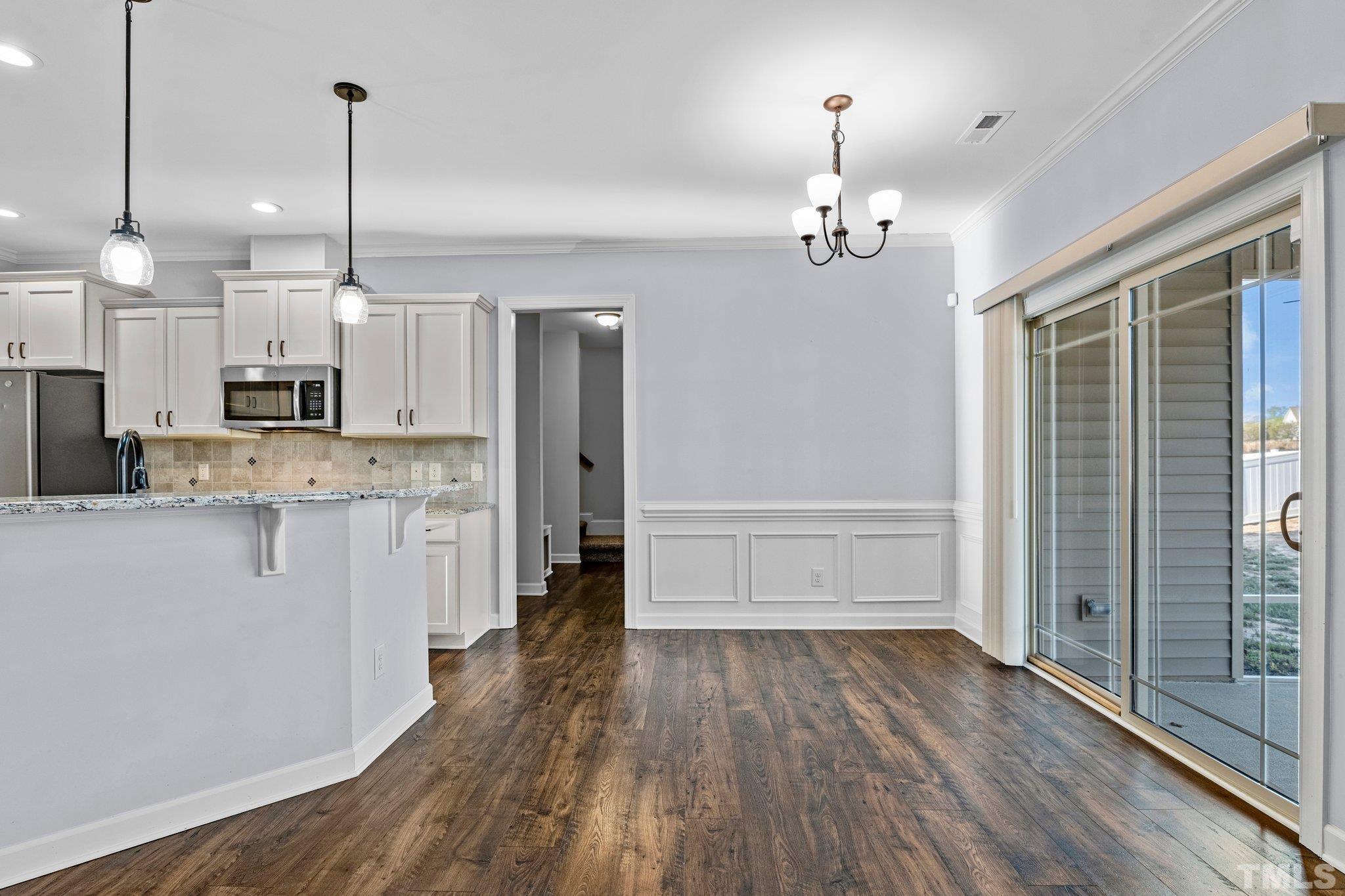97 Thunder Ridge Drive Garner, NC 27529 - Photo 13 of 33 a view of a kitchen with wooden floor and window