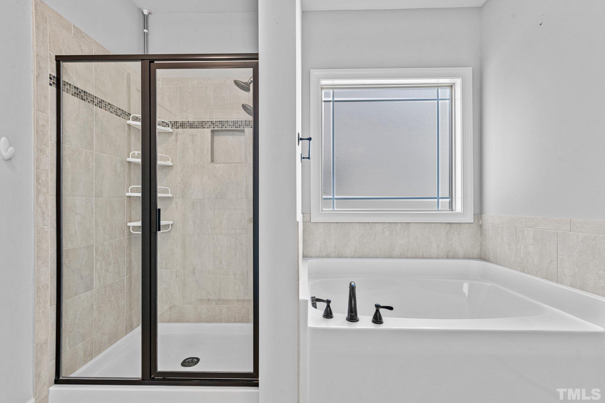 97 Thunder Ridge Drive Garner, NC 27529 - Photo 19 of 33 a bathroom with a bathtub and shower