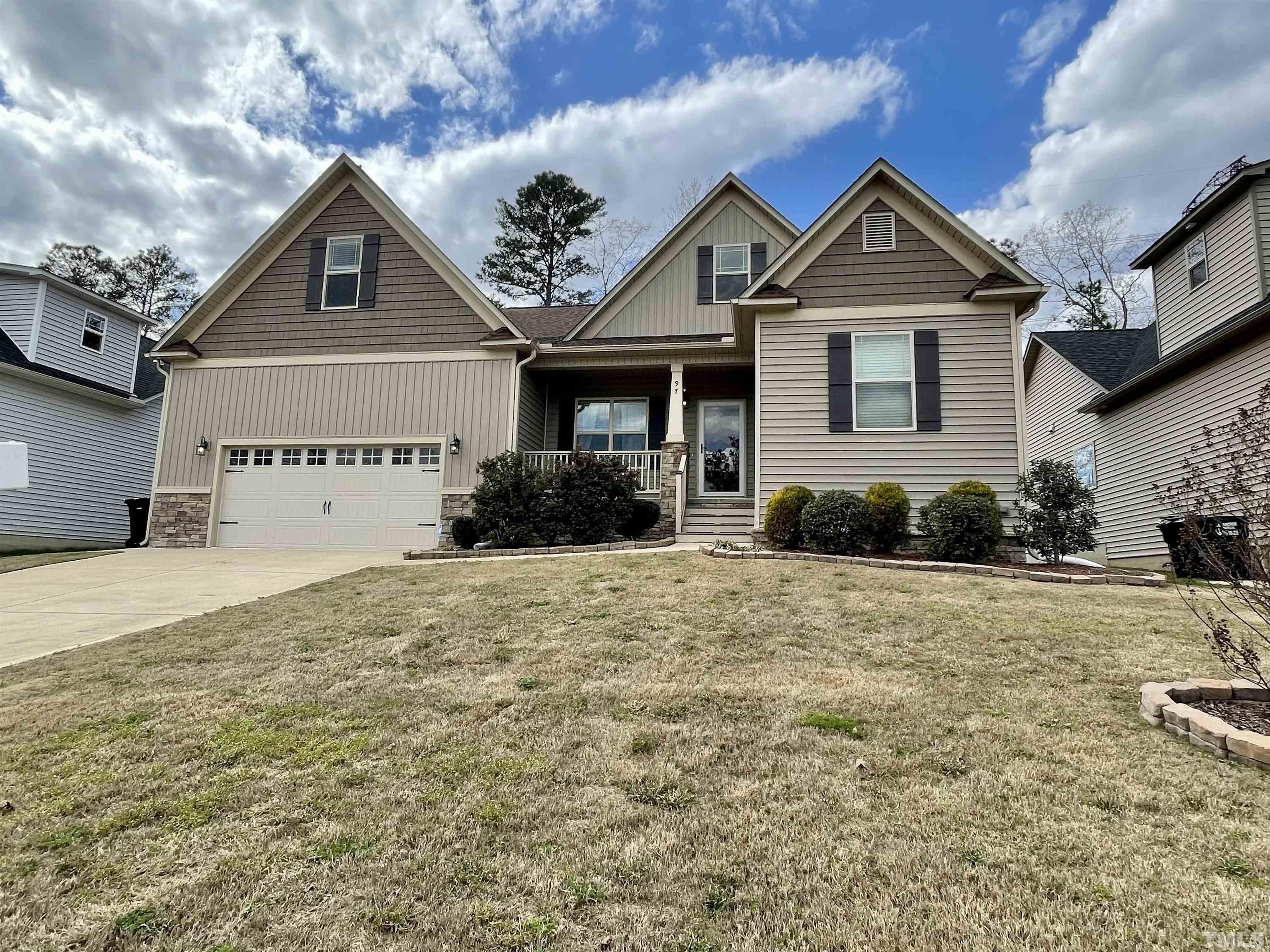 97 Thunder Ridge Drive Garner, NC 27529 - Photo 2 of 33 a front view of a house with a yard and garage