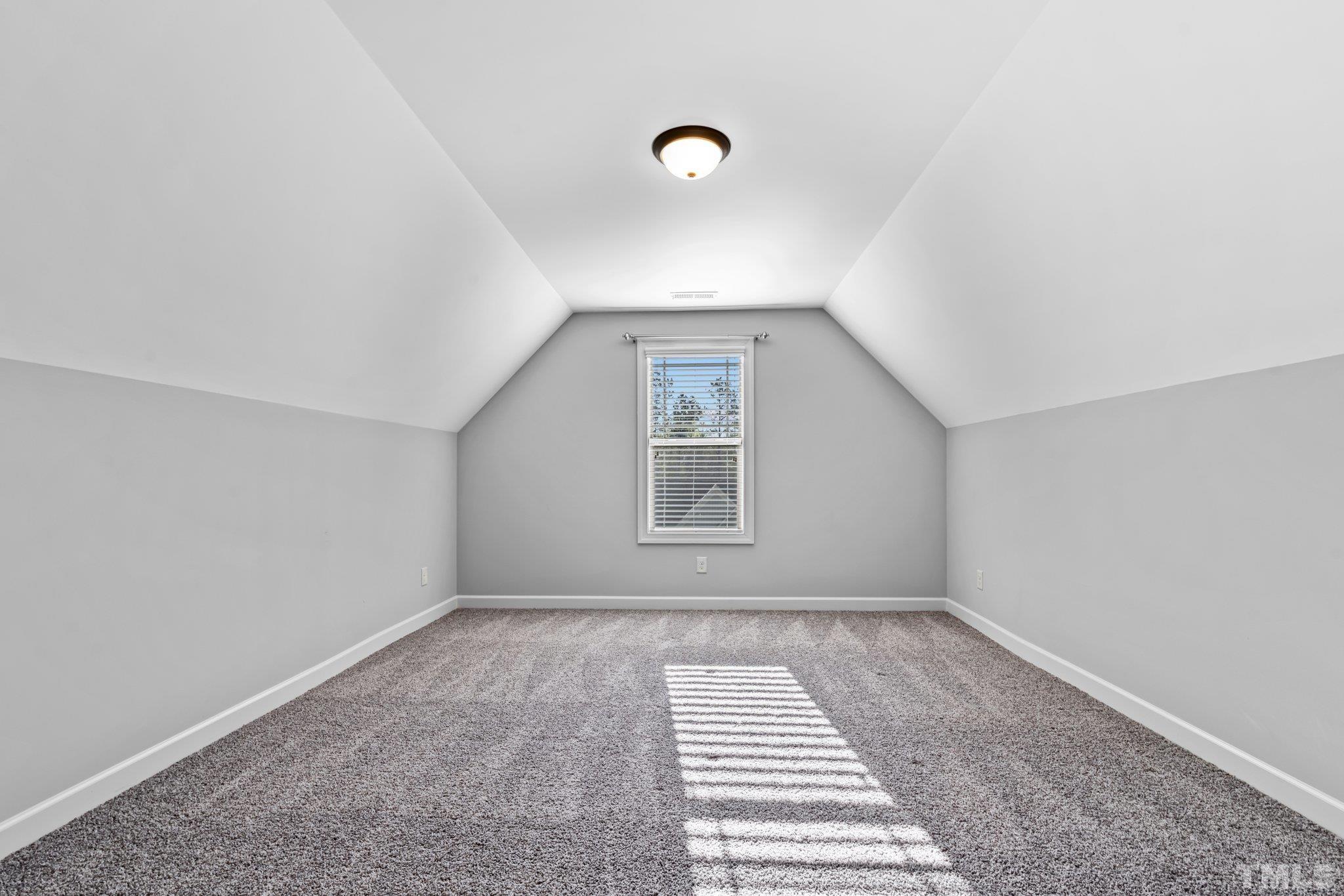 97 Thunder Ridge Drive Garner, NC 27529 - Photo 23 of 33 a view of an empty room with a window