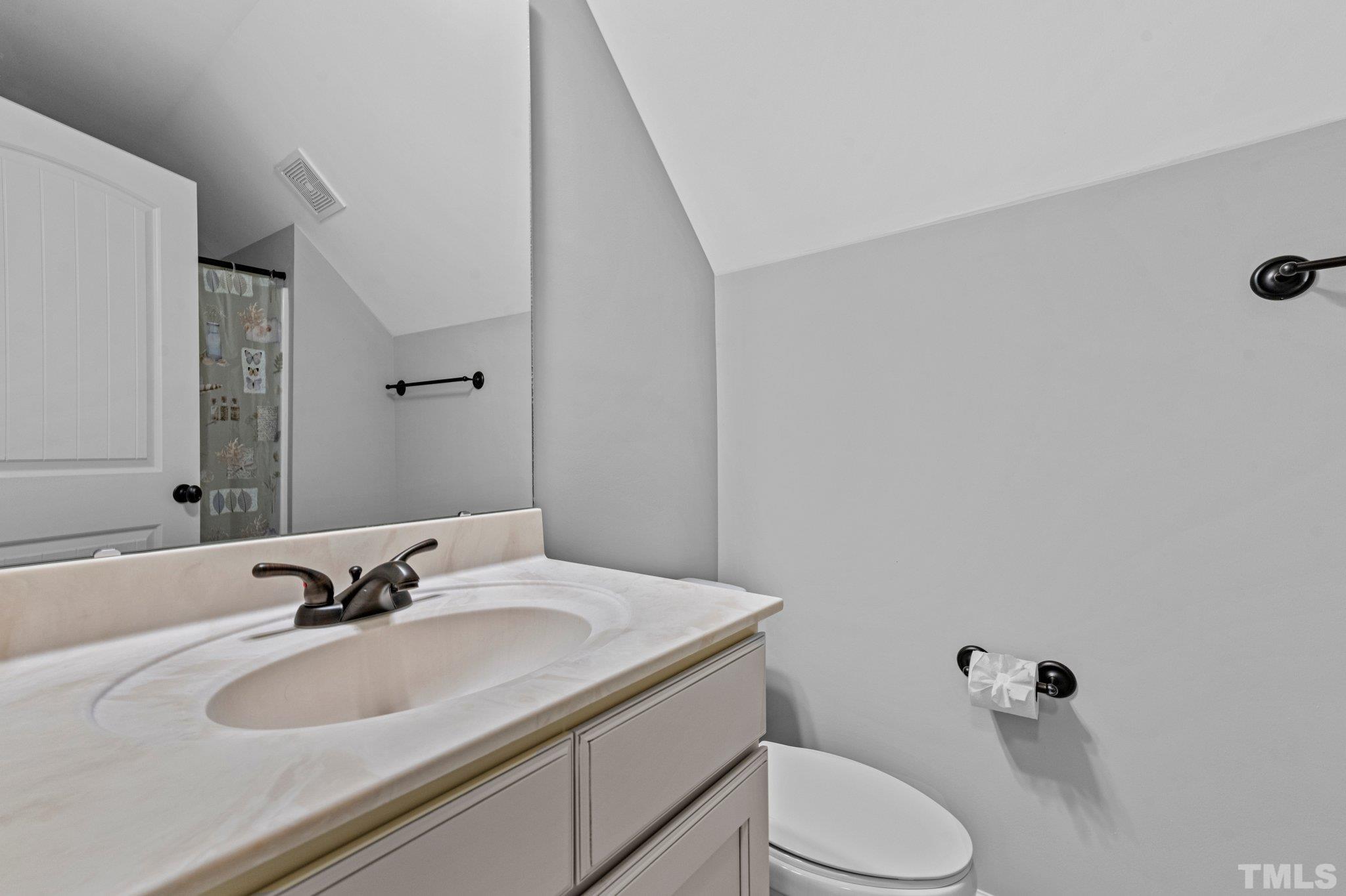 97 Thunder Ridge Drive Garner, NC 27529 - Photo 25 of 33 a bathroom with a sink toilet and mirror