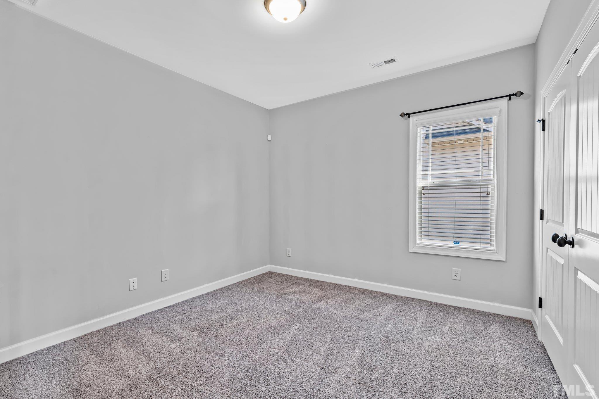 97 Thunder Ridge Drive Garner, NC 27529 - Photo 26 of 33 a view of an empty room with a window