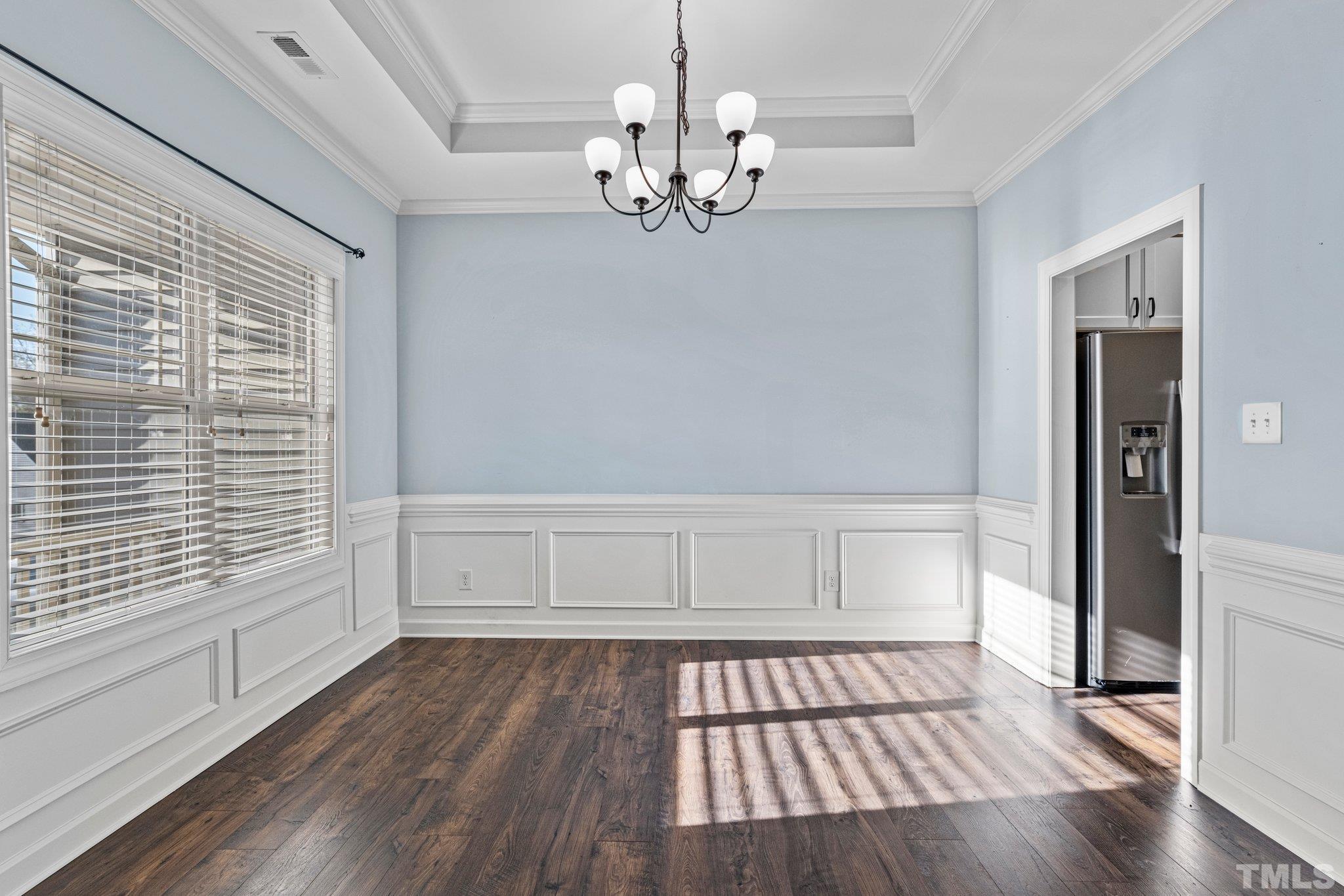 97 Thunder Ridge Drive Garner, NC 27529 - Photo 7 of 33 a view of an empty room with wooden floor and a window