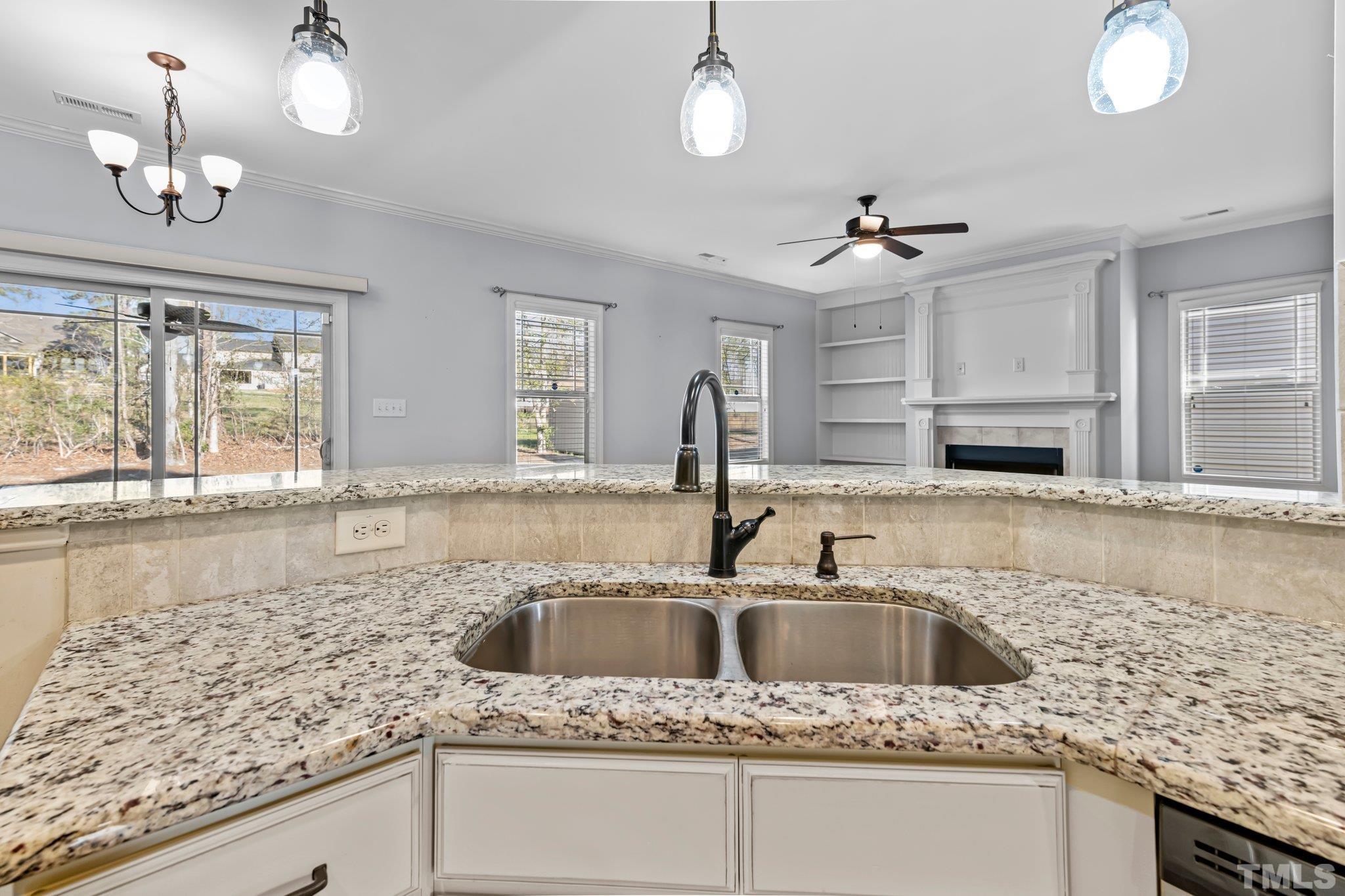 97 Thunder Ridge Drive Garner, NC 27529 - Photo 8 of 33 a kitchen with granite countertop a sink and a window