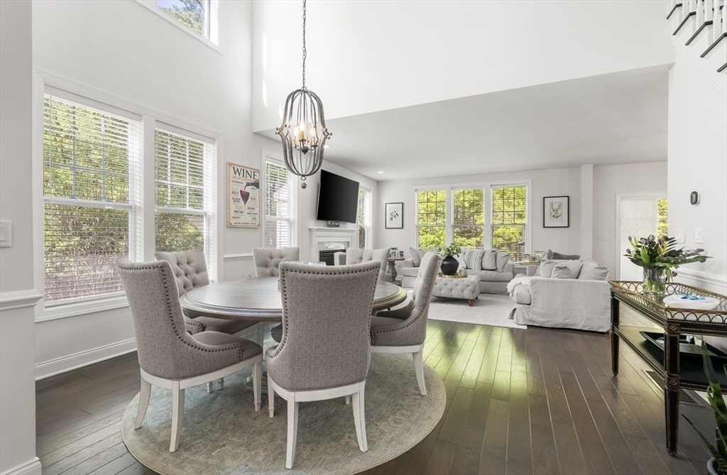 2 Hummingbird Way, Unit 1 Methuen, MA 01844 - Photo 5 of 42 a dining room with wooden floor a chandelier a glass table and chairs