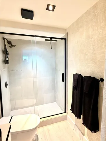 a bathroom with a shower and a tub