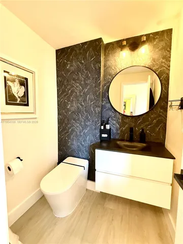 a bathroom with a sink mirror and vanity
