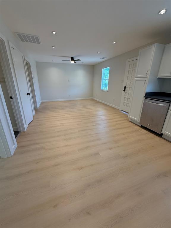 3113 Navaro Street Dallas, TX 75212 - Photo 2 of 12 an empty room with wooden floor and windows