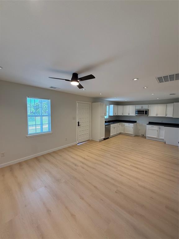 3113 Navaro Street Dallas, TX 75212 - Photo 3 of 12 an empty room with wooden floor and windows