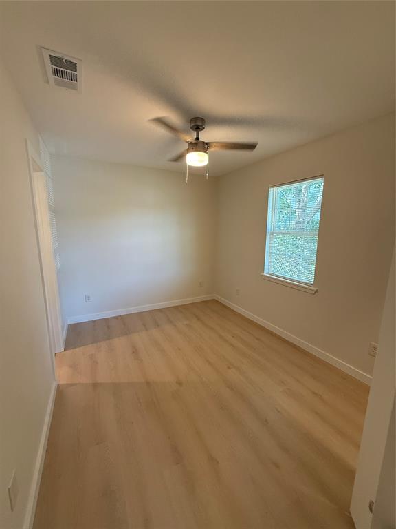 3113 Navaro Street Dallas, TX 75212 - Photo 4 of 12 an empty room with a window and a ceiling fan