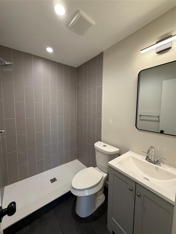 3113 Navaro Street Dallas, TX 75212 - Photo 6 of 12 a bathroom with a double vanity sink toilet and a mirror