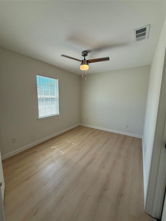 3113 Navaro Street Dallas, TX 75212 - Photo 7 of 12 an empty room with a ceiling fan and window