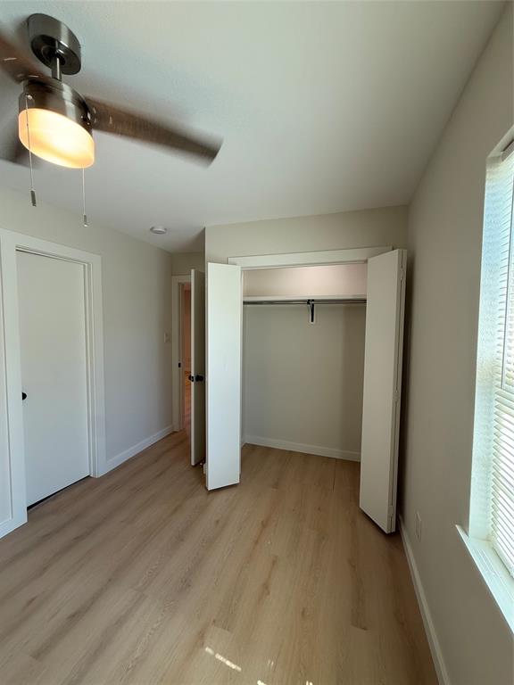 3113 Navaro Street Dallas, TX 75212 - Photo 8 of 12 an empty room with wooden floor and windows