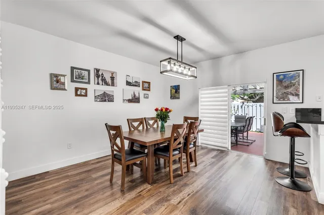 a view of a dining room with furniture wooden floor and chandelier