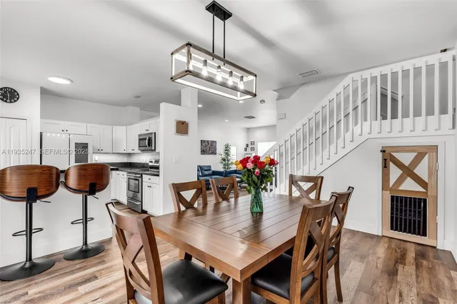 a view of a dining room with furniture and chandelier
