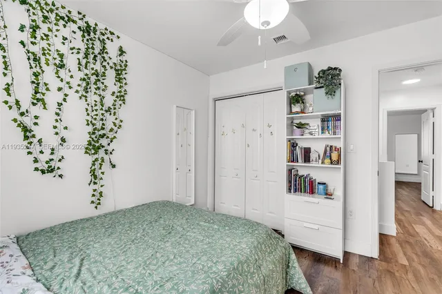 a bedroom with a bed and a book shelf