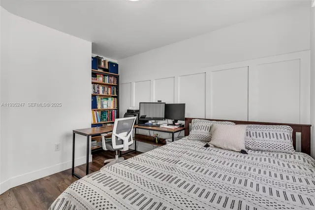 a bedroom with a bed and a book shelf