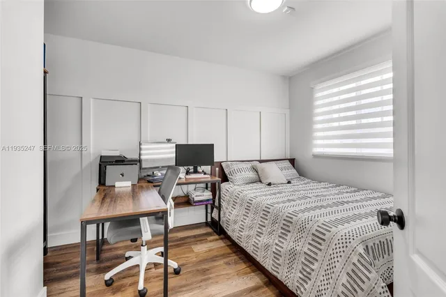 a bedroom with a bed and a table in it