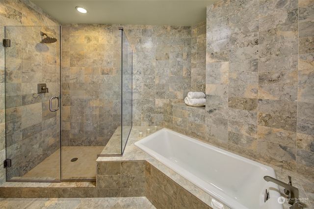 a bathroom with a bathtub and shower