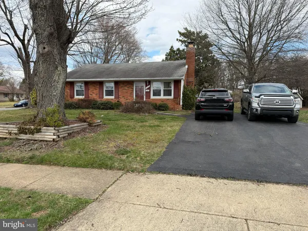 a view of a car parked in front of a brick house