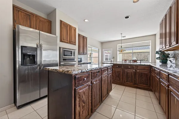 a kitchen with stainless steel appliances granite countertop a stove top oven a sink and dishwasher