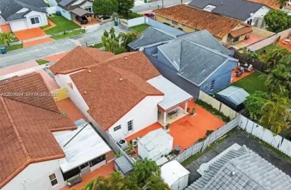 an aerial view of a house with a yard