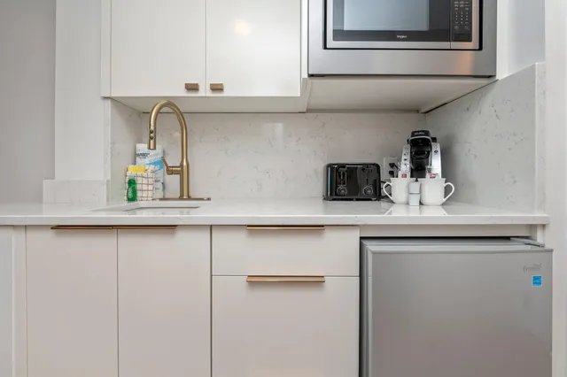 a kitchen with stainless steel appliances a sink and cabinets