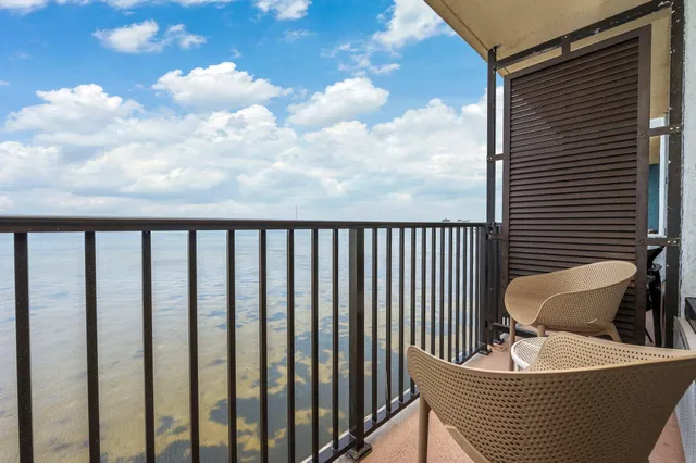 a balcony with table and chairs