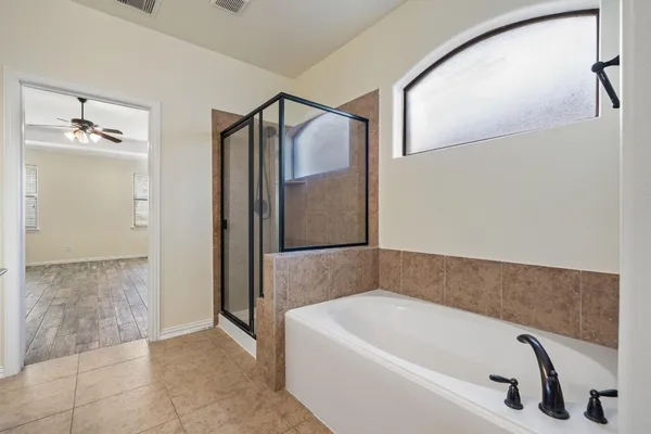 a bathroom with a tub and shower