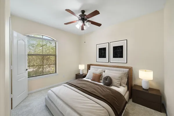 a bedroom with a large bed and a window