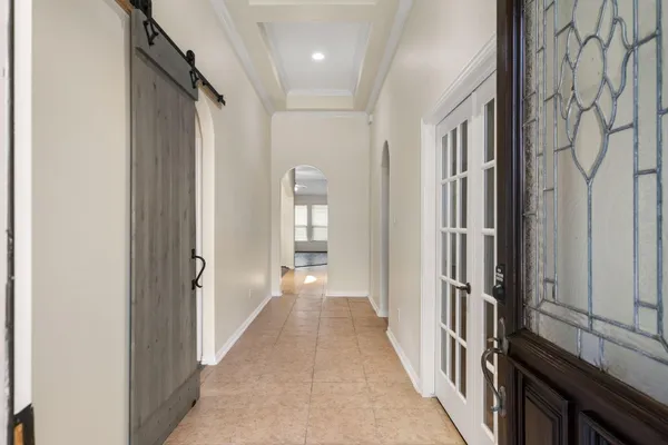 a view of a hallway with a wooden door