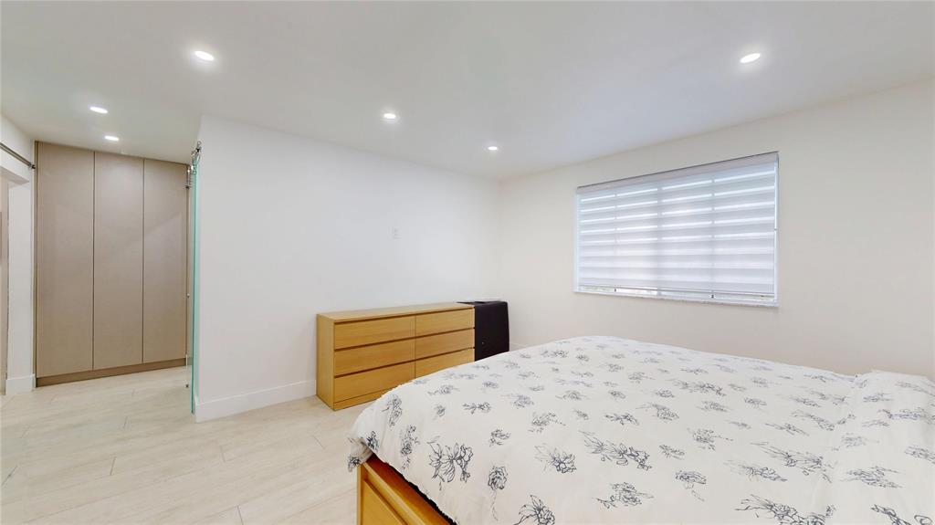 4060 Southwest 70th Terrace Davie, FL 33314 - Photo 18 of 22 a bedroom with a bed and a window