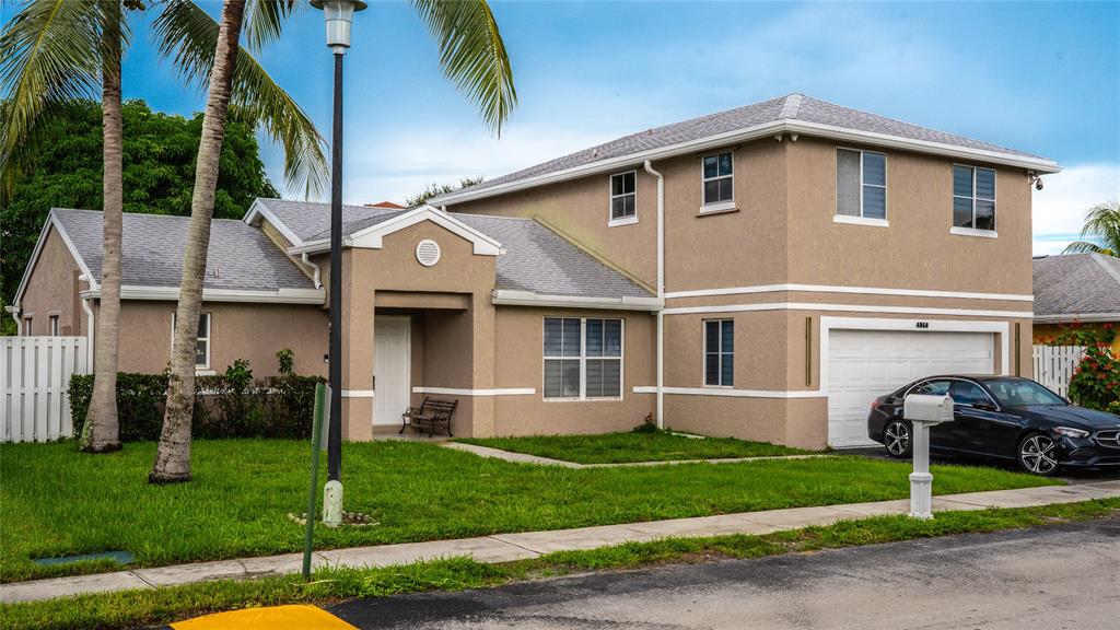 4060 Southwest 70th Terrace Davie, FL 33314 - Photo 2 of 22 a front view of a house with a garden and plants