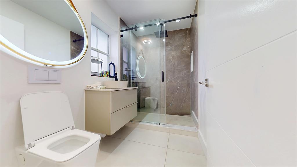 4060 Southwest 70th Terrace Davie, FL 33314 - Photo 3 of 22 a bathroom with a sink a mirror and a shower