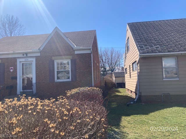 1650 Hillview Road Cleveland, OH 44112 - Photo 3 of 10 View of home's exterior with a lawn