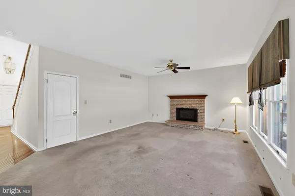 a view of an empty room with a fireplace