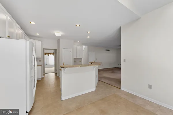 a view of a big room with kitchen and windows
