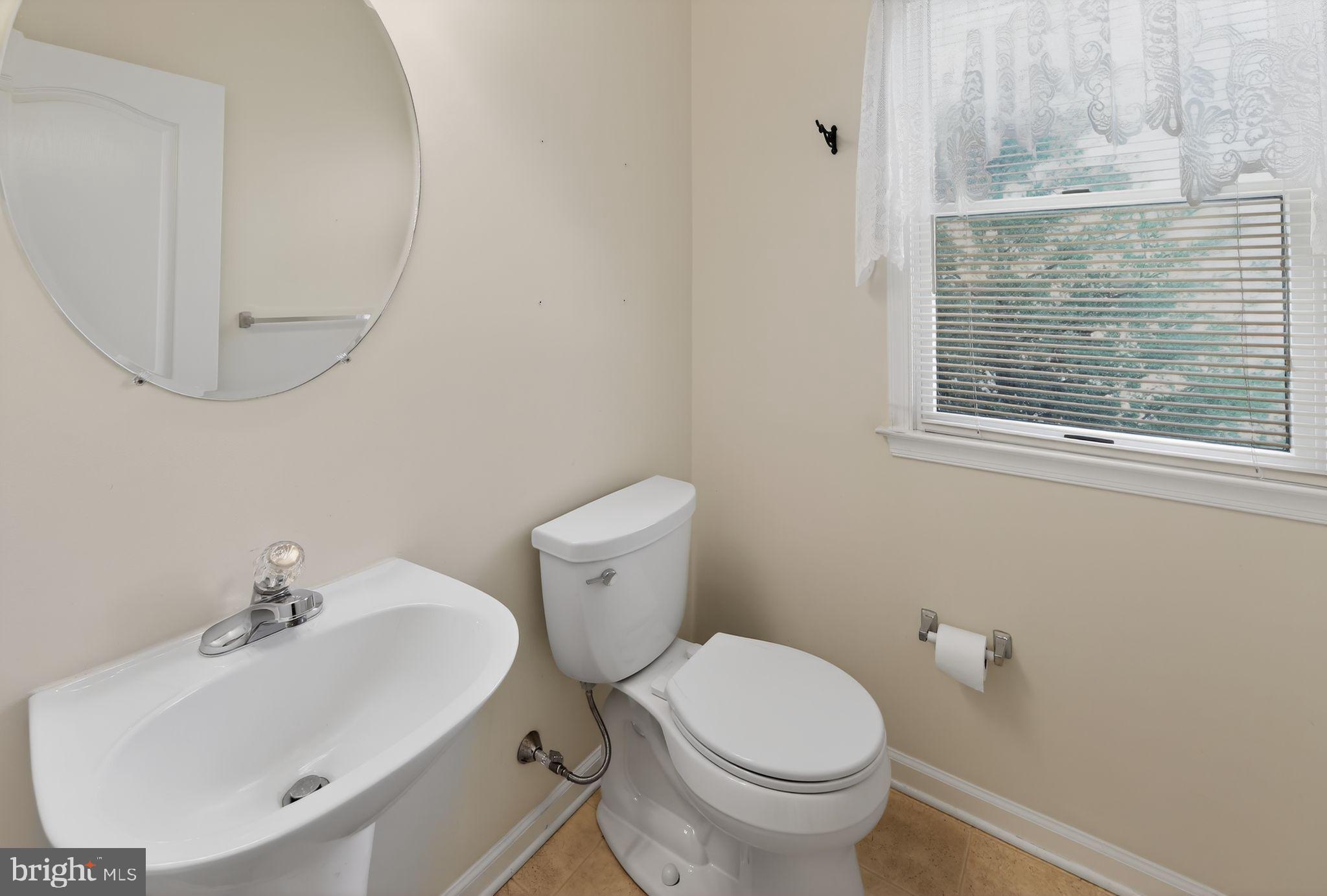 221 Cullen Way Newark, DE 19711 - Photo 26 of 37 a bathroom with a sink a toilet and a mirror